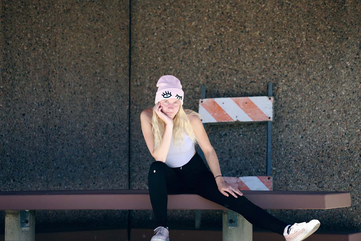 people woman sitting on brown bench person