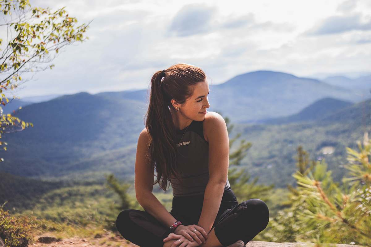 person woman sitting on ground outdoors