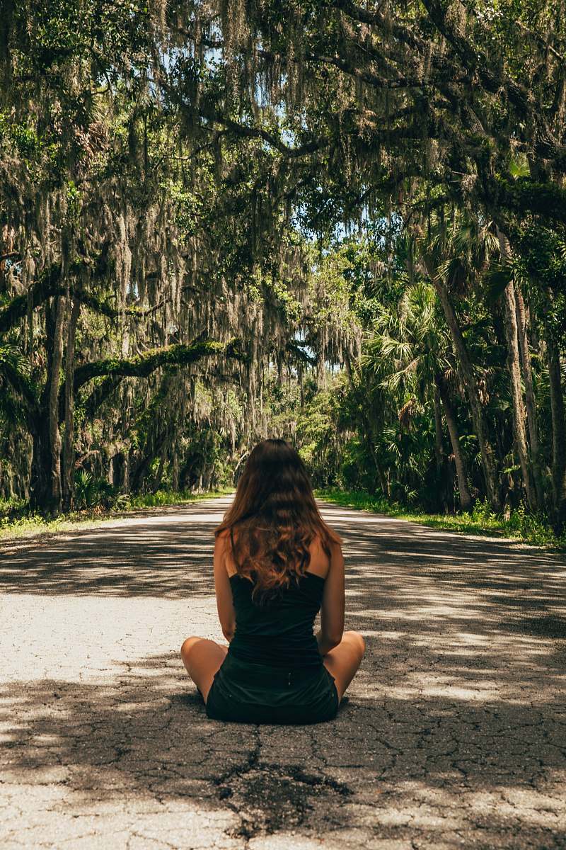 person woman sitting on road during daytime people