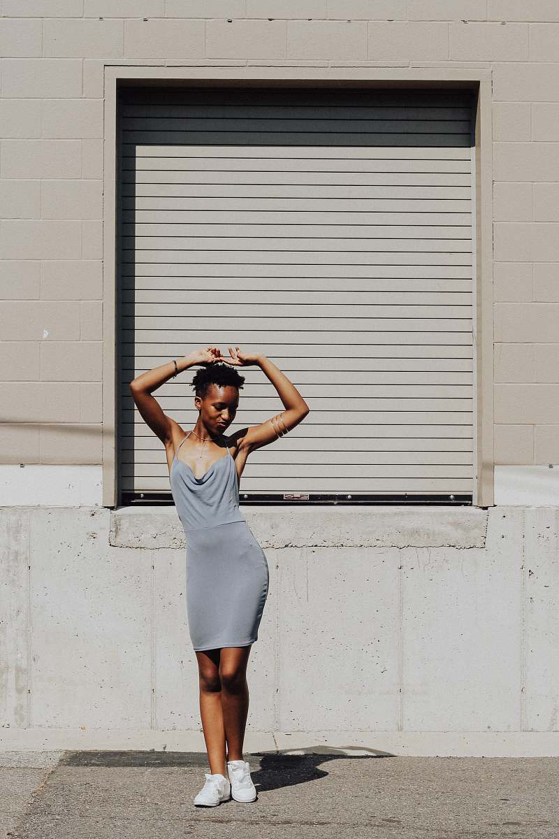 person woman standing near white window people