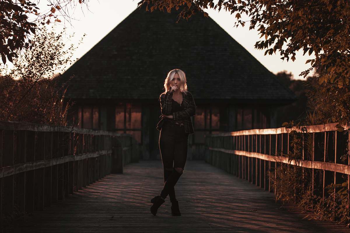 person woman standing on bridge people