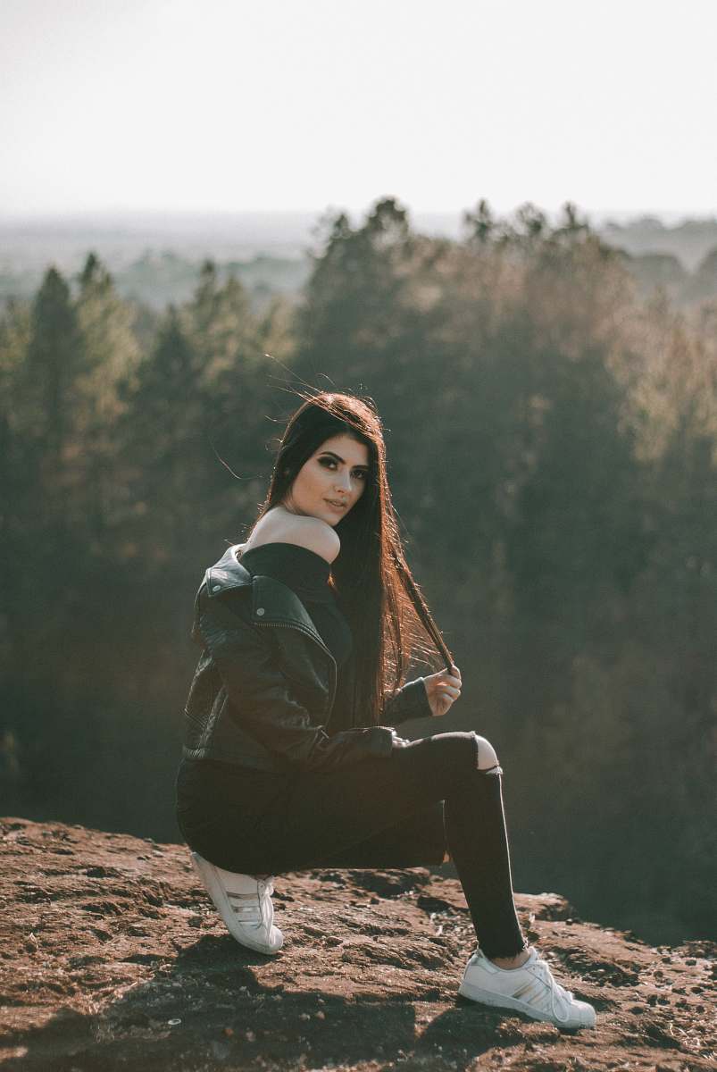 person woman standing on brown mountain during daytime people