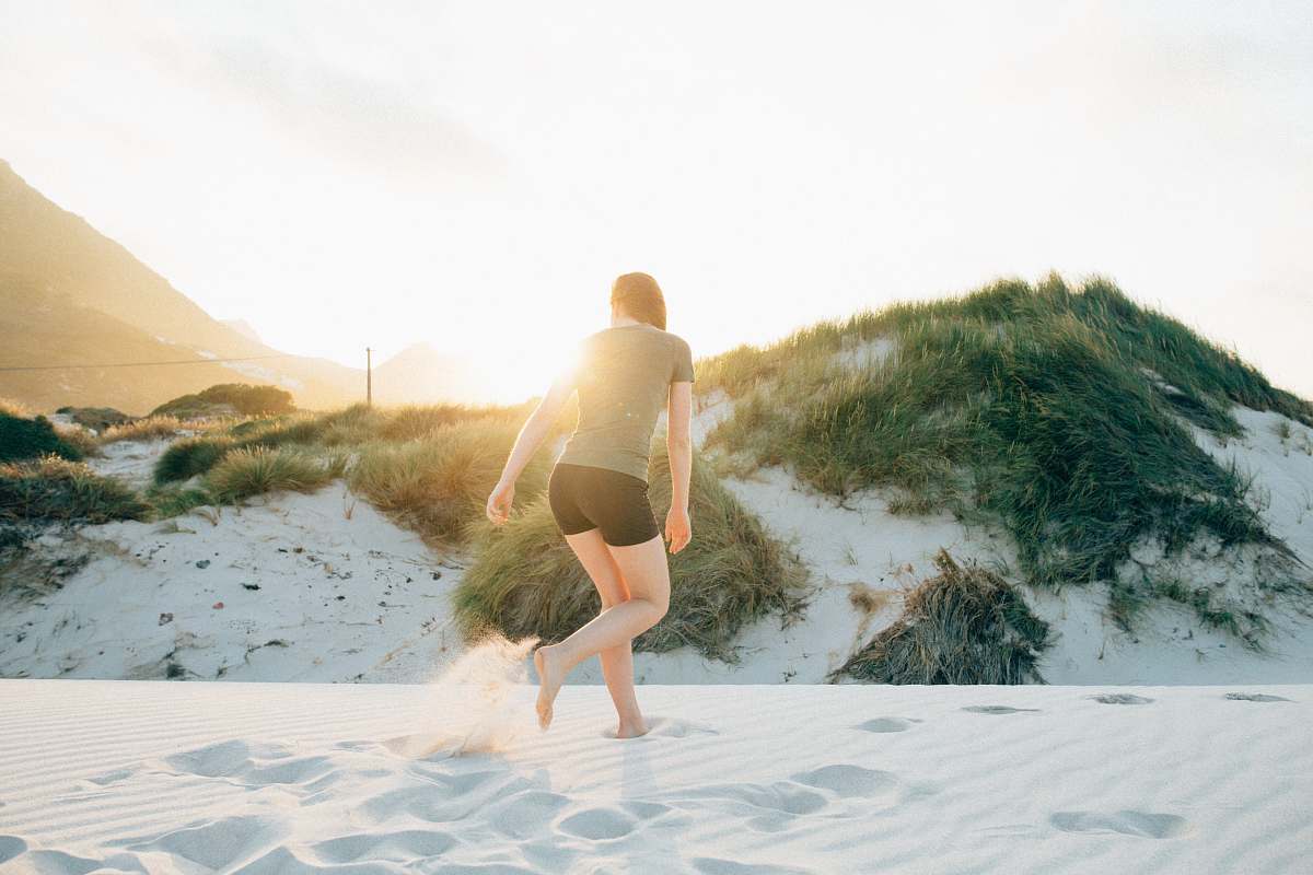 person woman standing on white stand during golden hour exercise