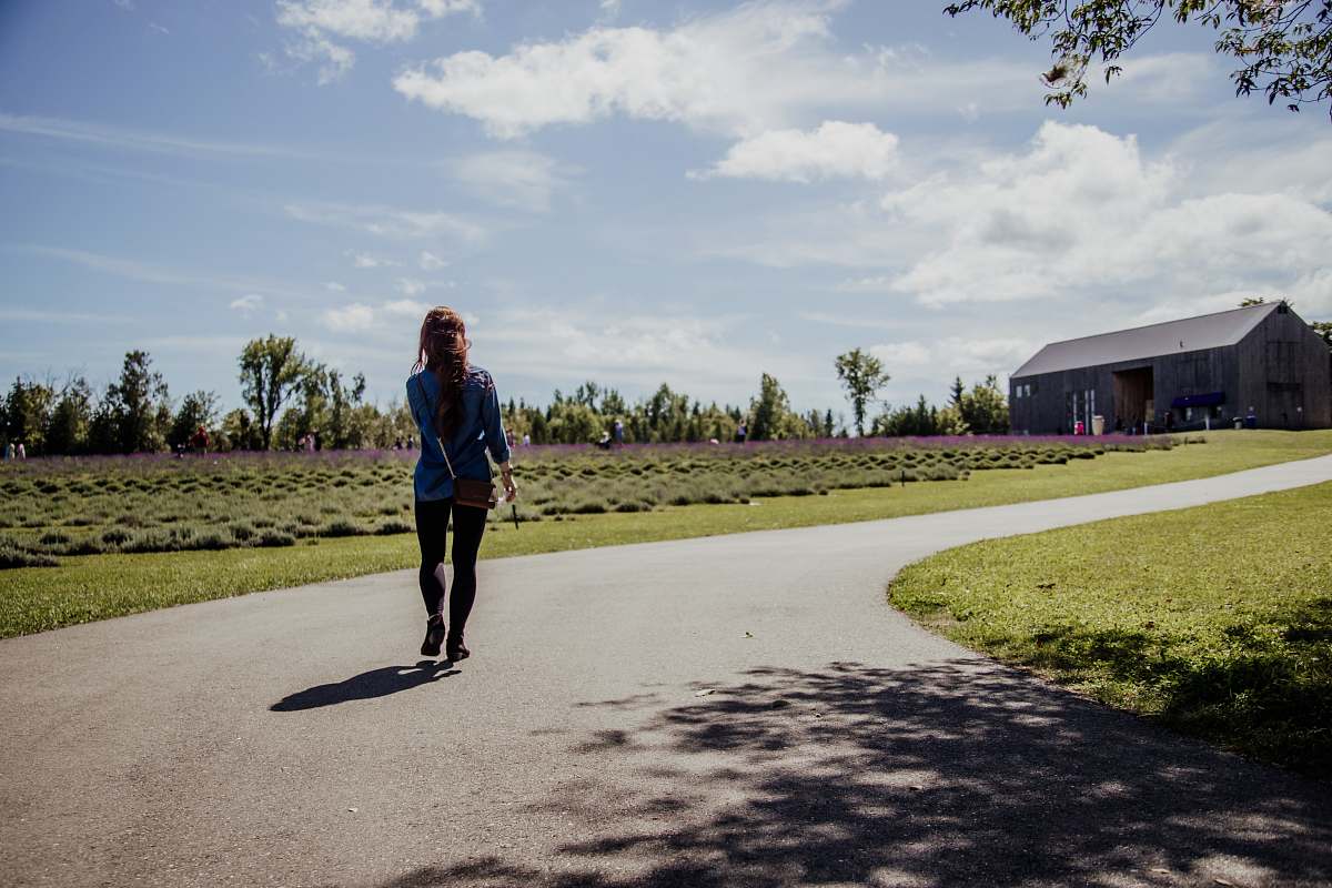 person woman walking in road outdoors
