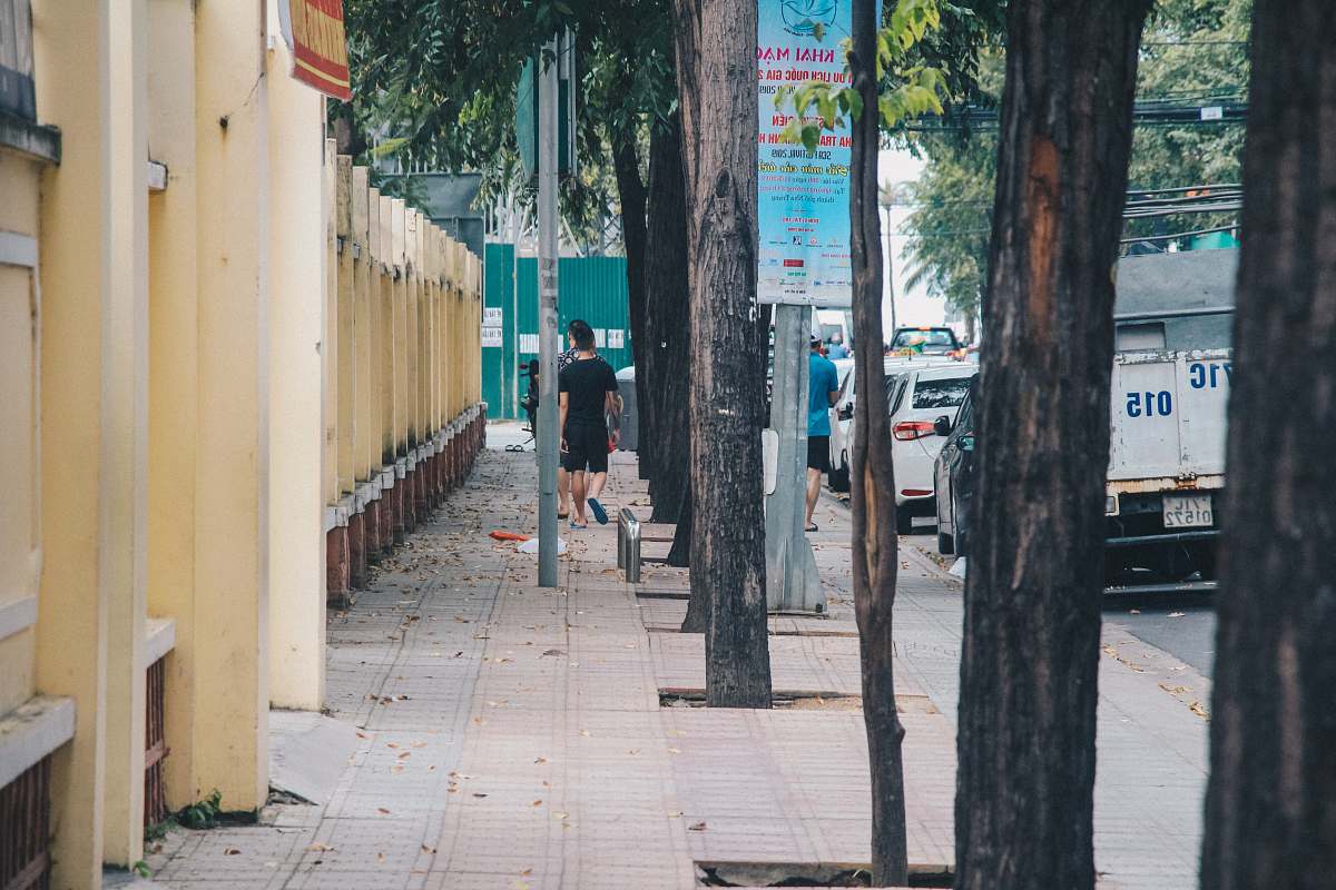 person woman walking near the wall path