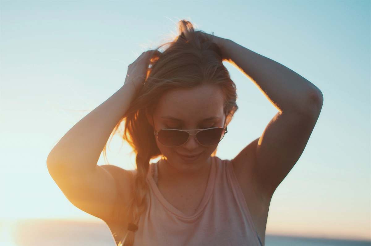 person woman wearing beige tank top against sunrise people