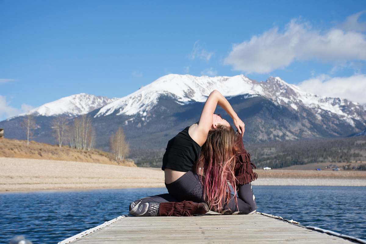 person woman wearing black camisole on dock water