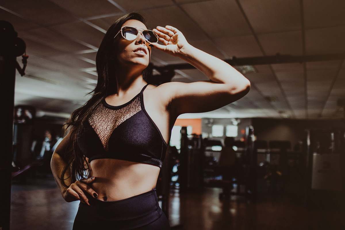 person woman wearing black sports bra accessories