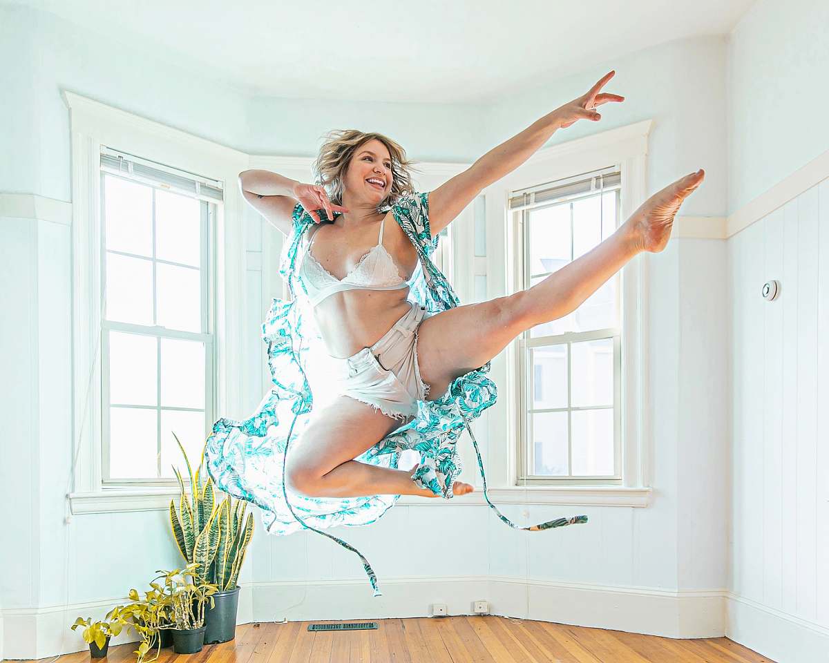 person woman wearing blue cardigan jumping dance