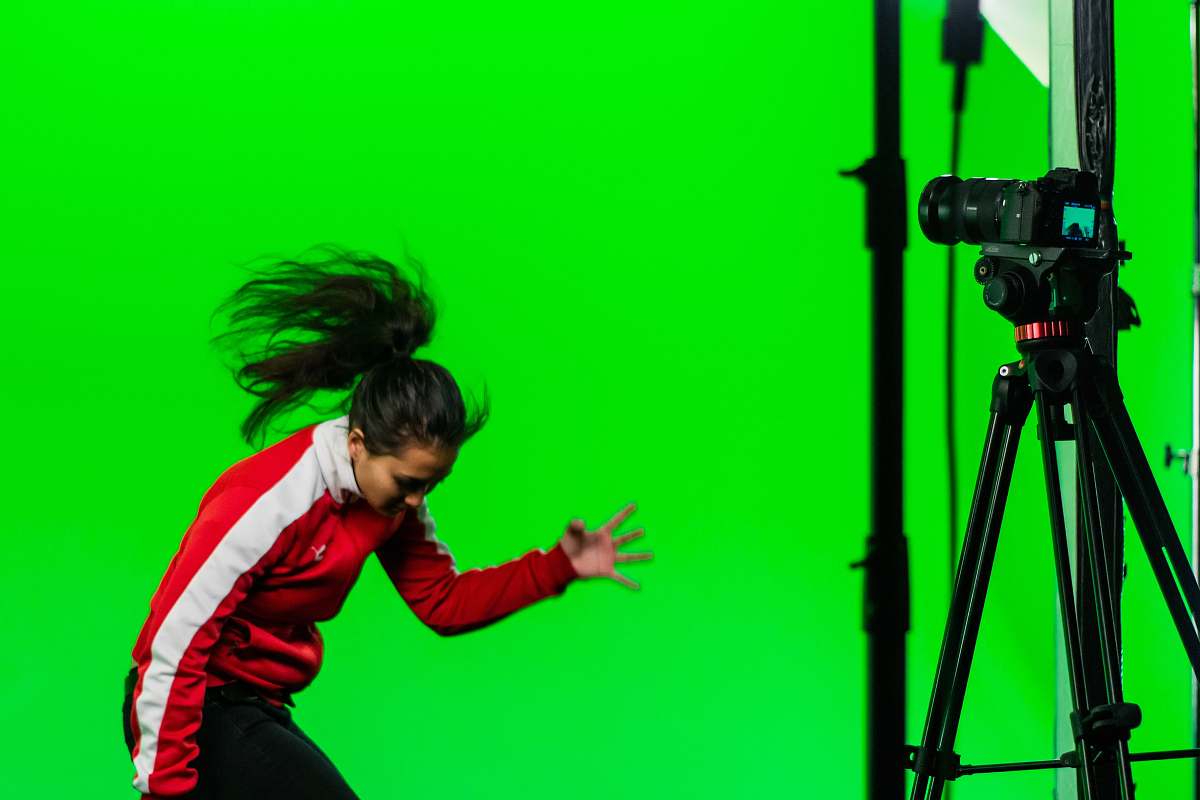 person woman wearing red and white track suit tripod