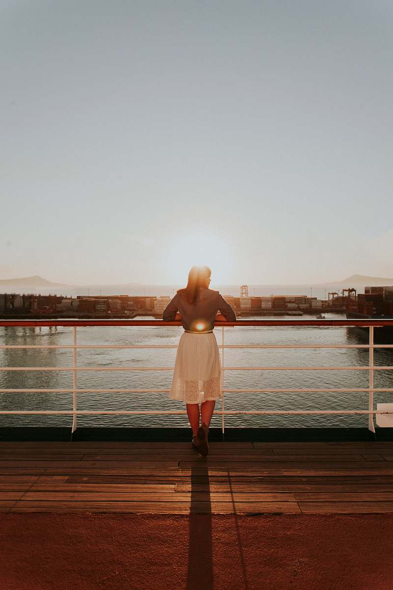 person woman wearing white skirt looking at body of water during daytime people