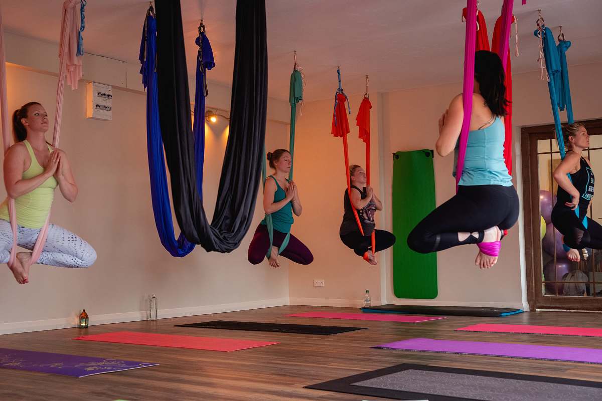 person women doing yoga inside room working out
