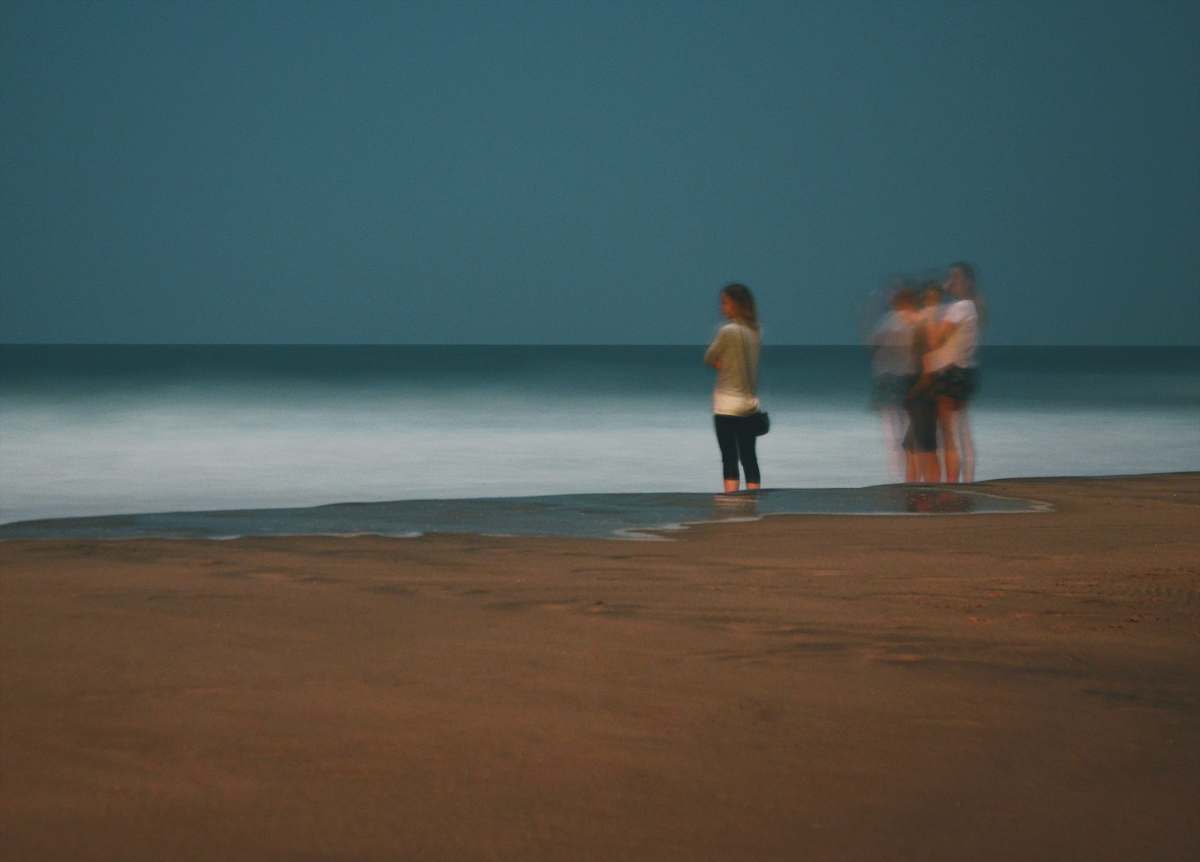 person women standing on seashore apparel
