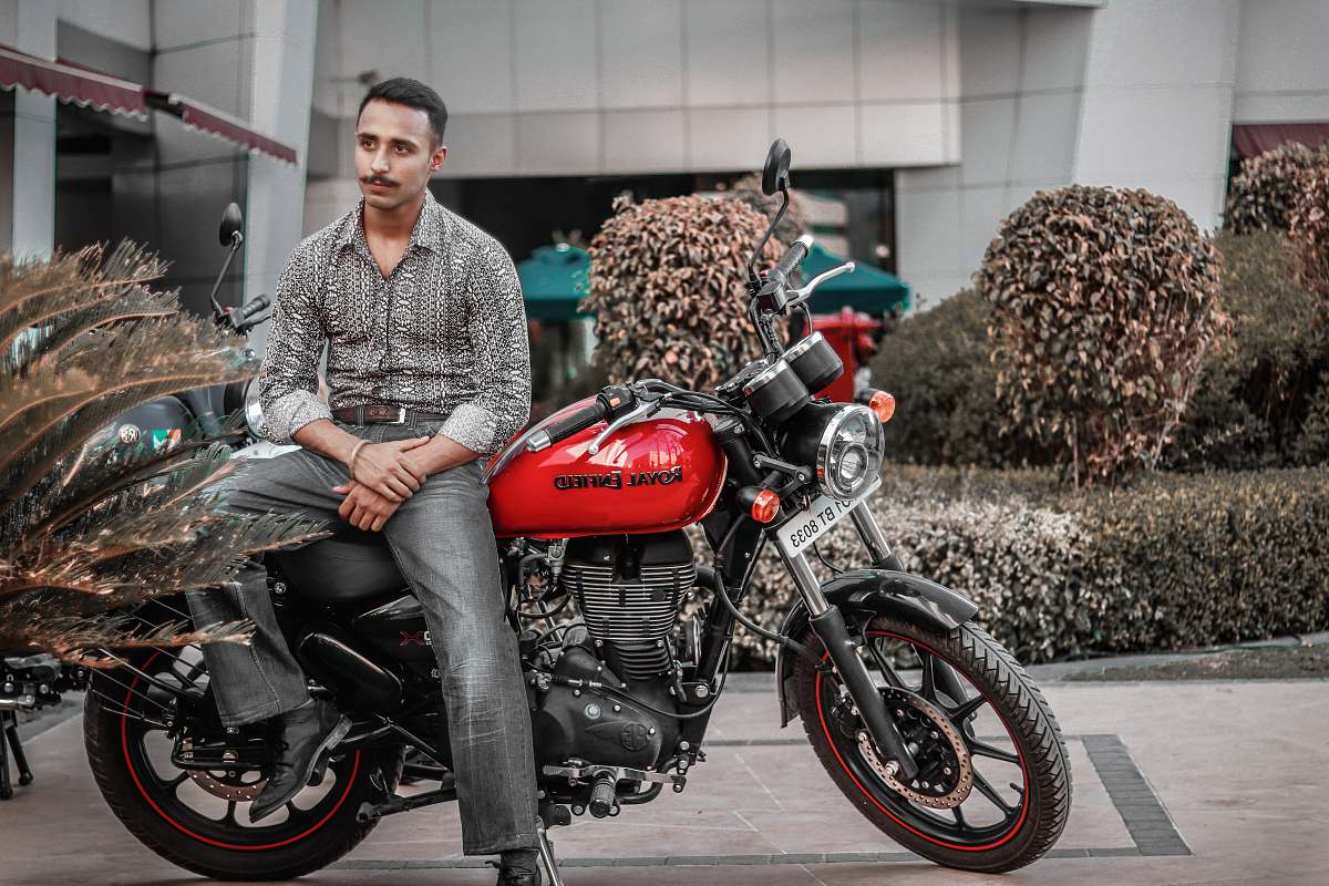 transportation man on a red and black motorcycle vehicle