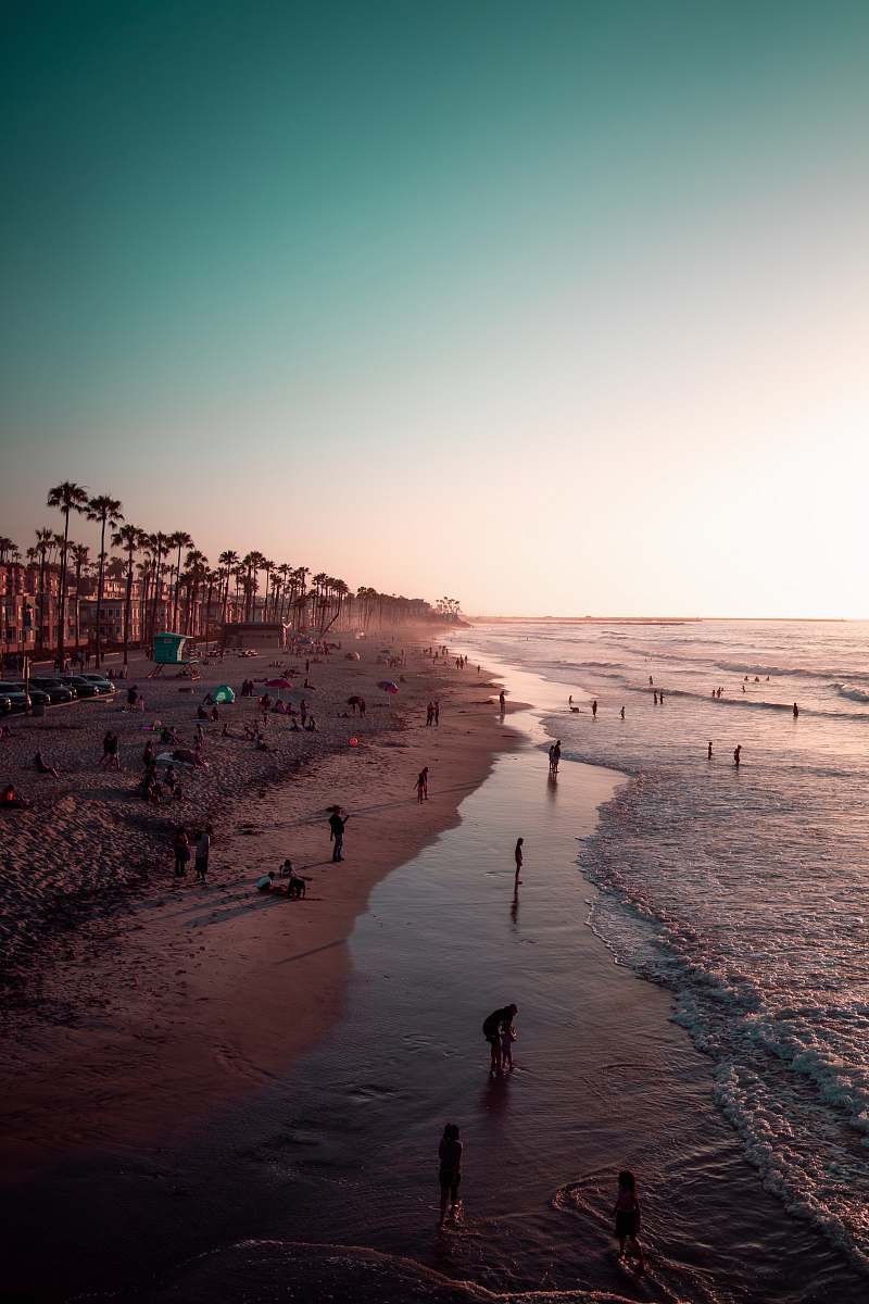 water people on shore during daytime ocean