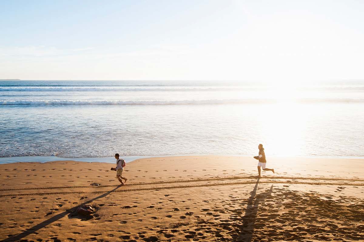 water man chasing child in beach nature