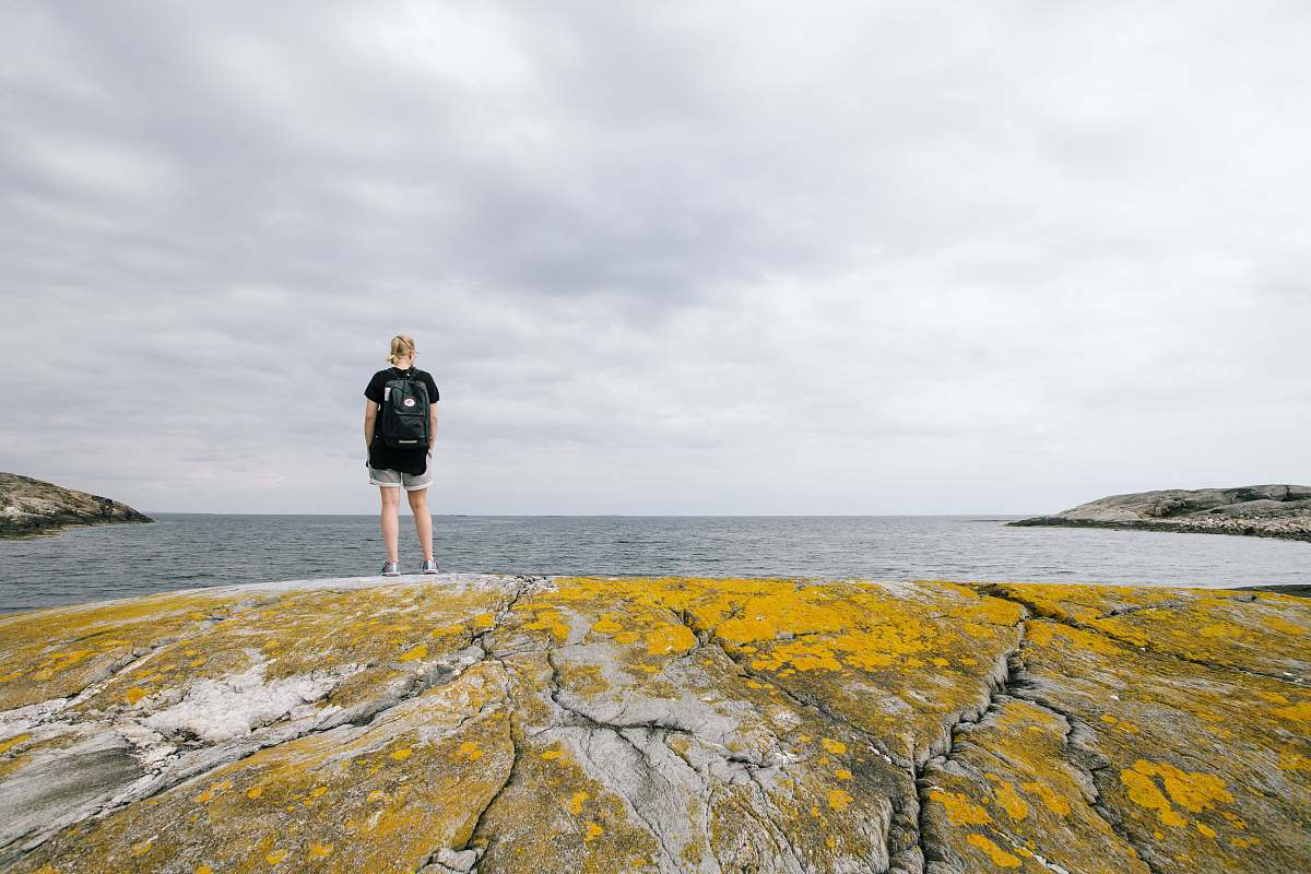 sea woman standing near body of water during daytime water