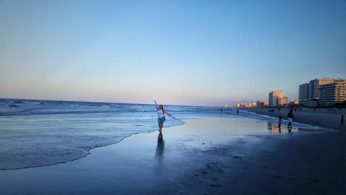 nature woman walking on seashore shoreline