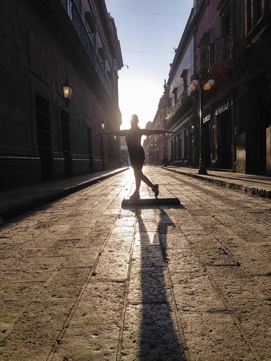 walkway woman standing on exercise board on street pavement