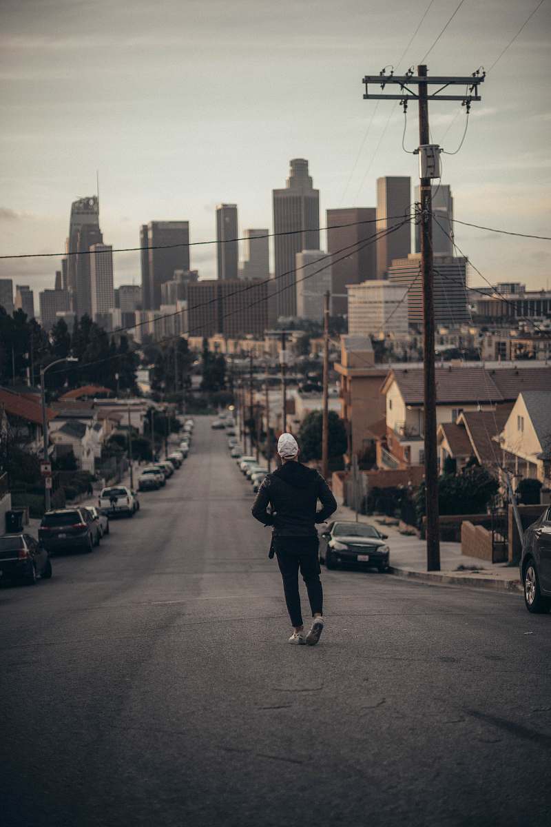 person man walking on road during daytime human