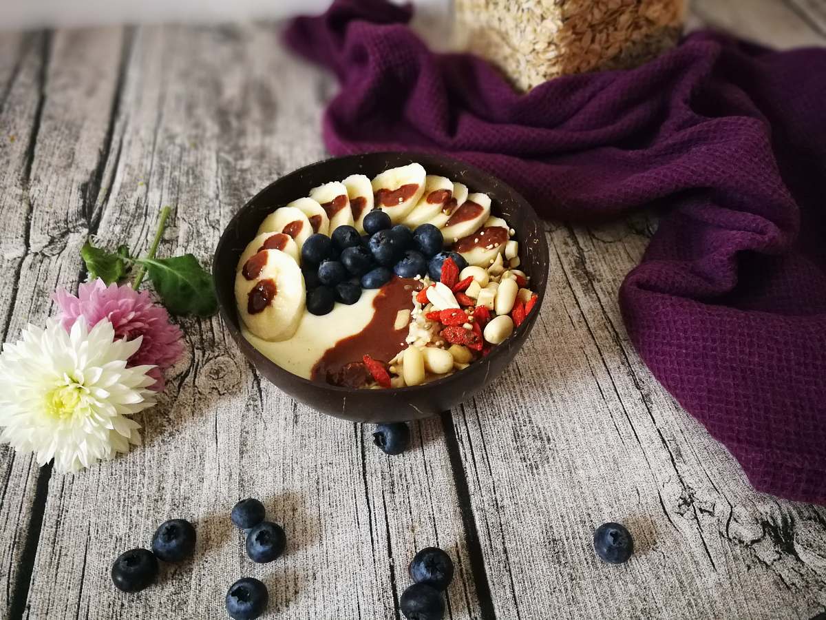 human blueberries and nuts with brown syrup in brown bowl person