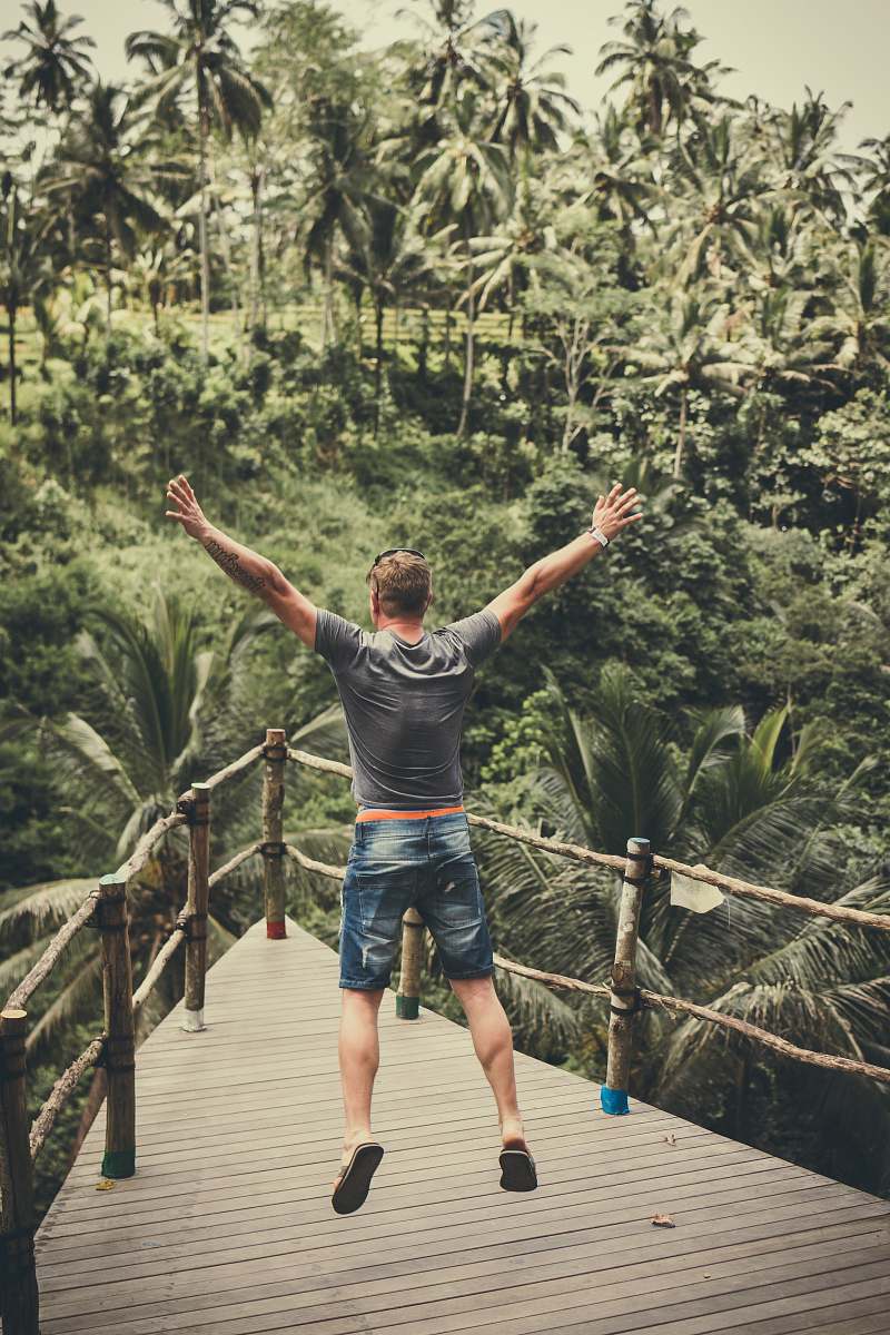 person man jumping and raising his arms human