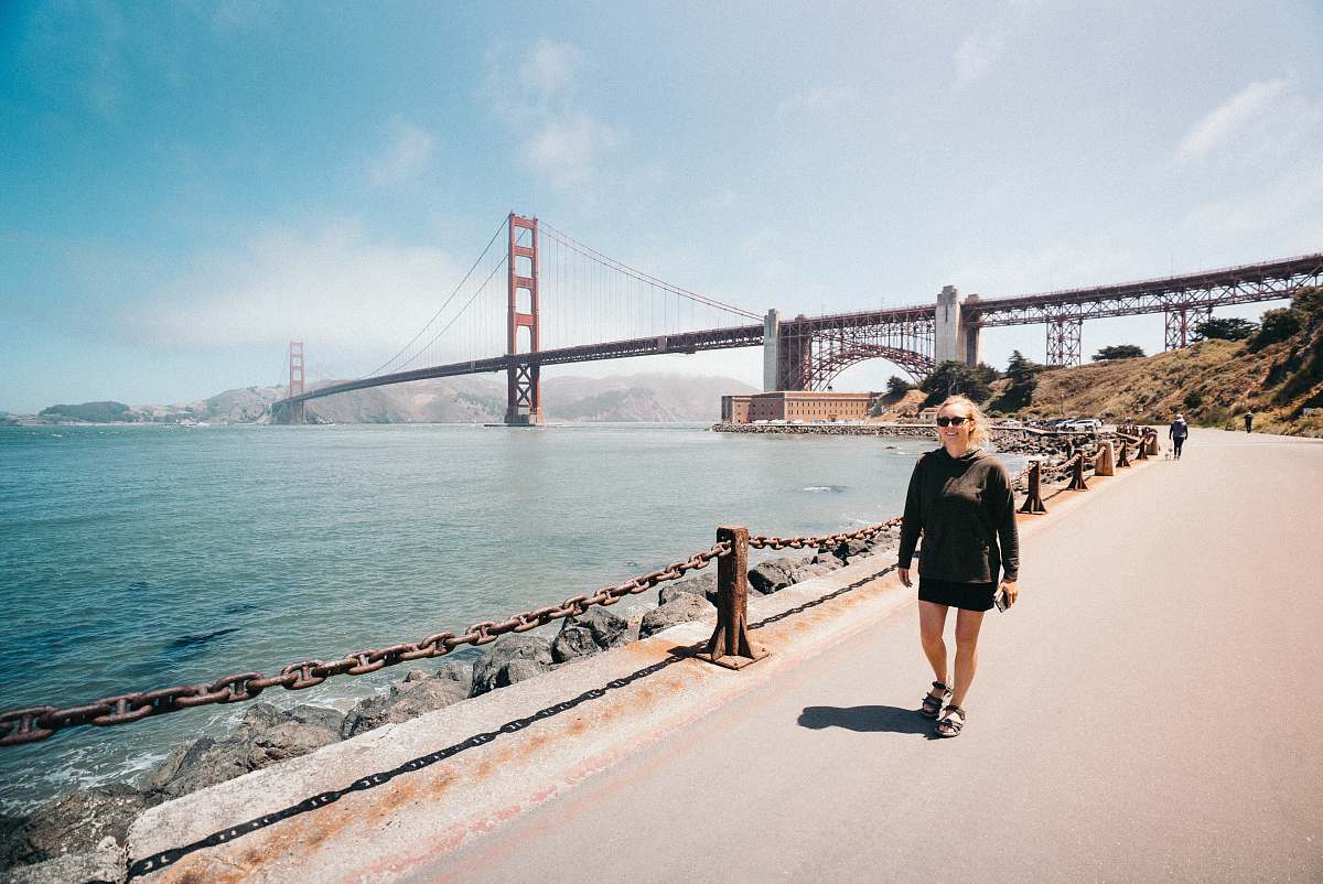 human woman walking near Golden Gate Bridge bridge