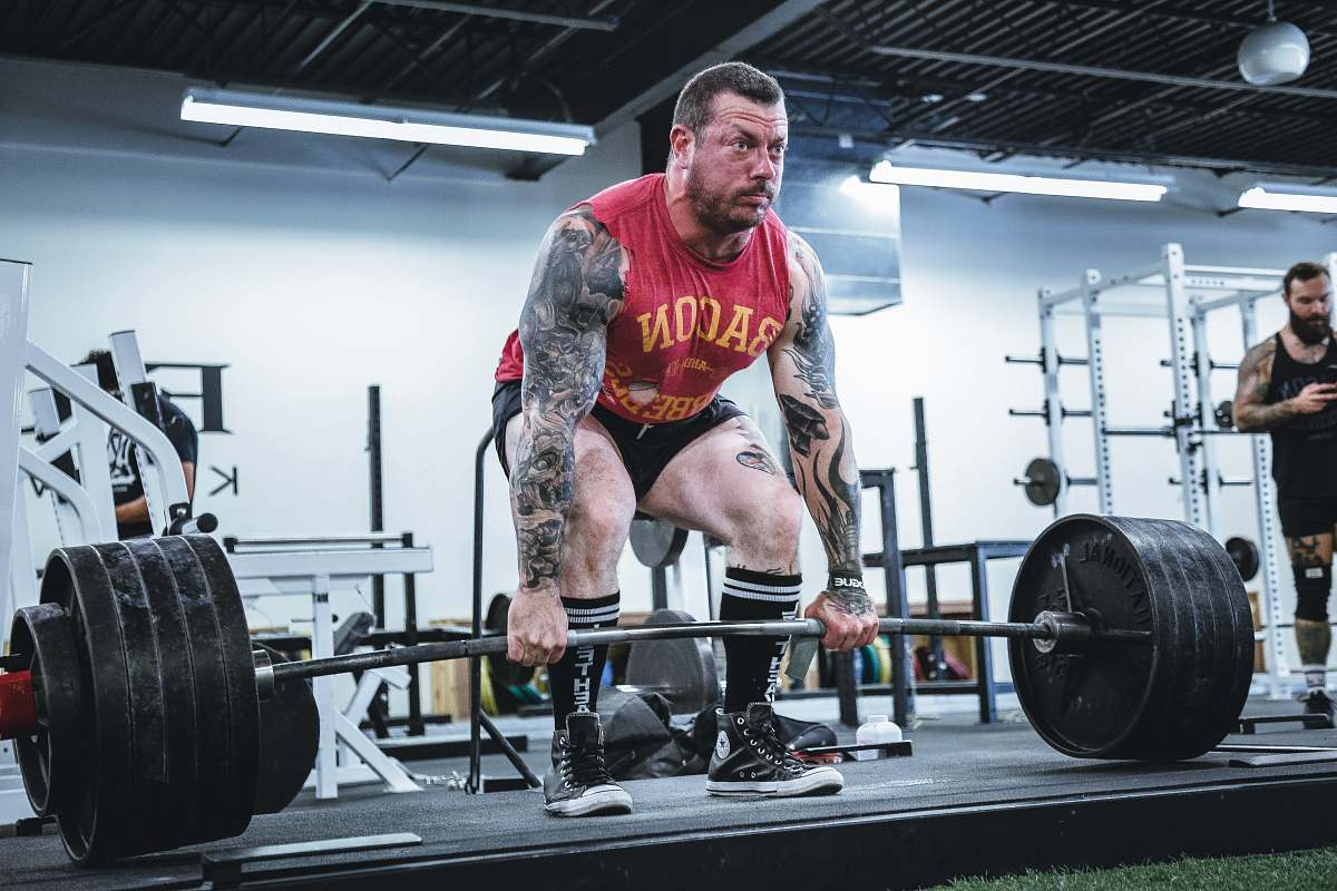 human black adjustable-weight barbell people
