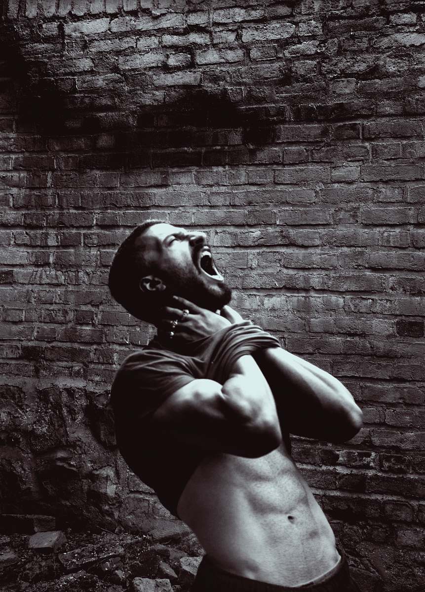brick grayscale photo of man wall