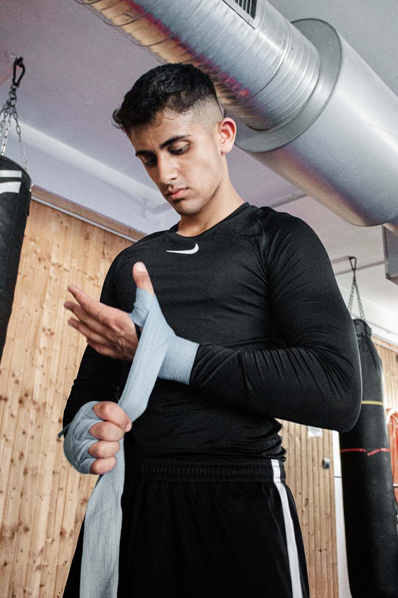 human man bandaging his wrist apparel