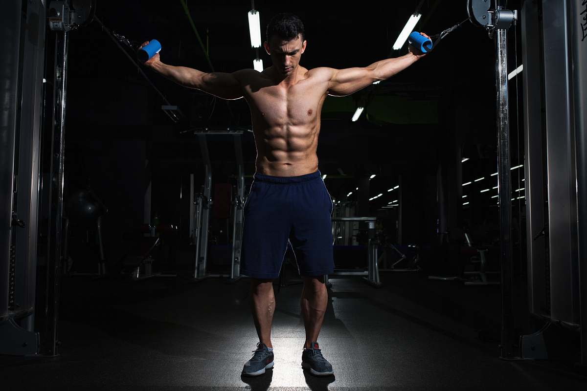 human man exercising inside dim room man
