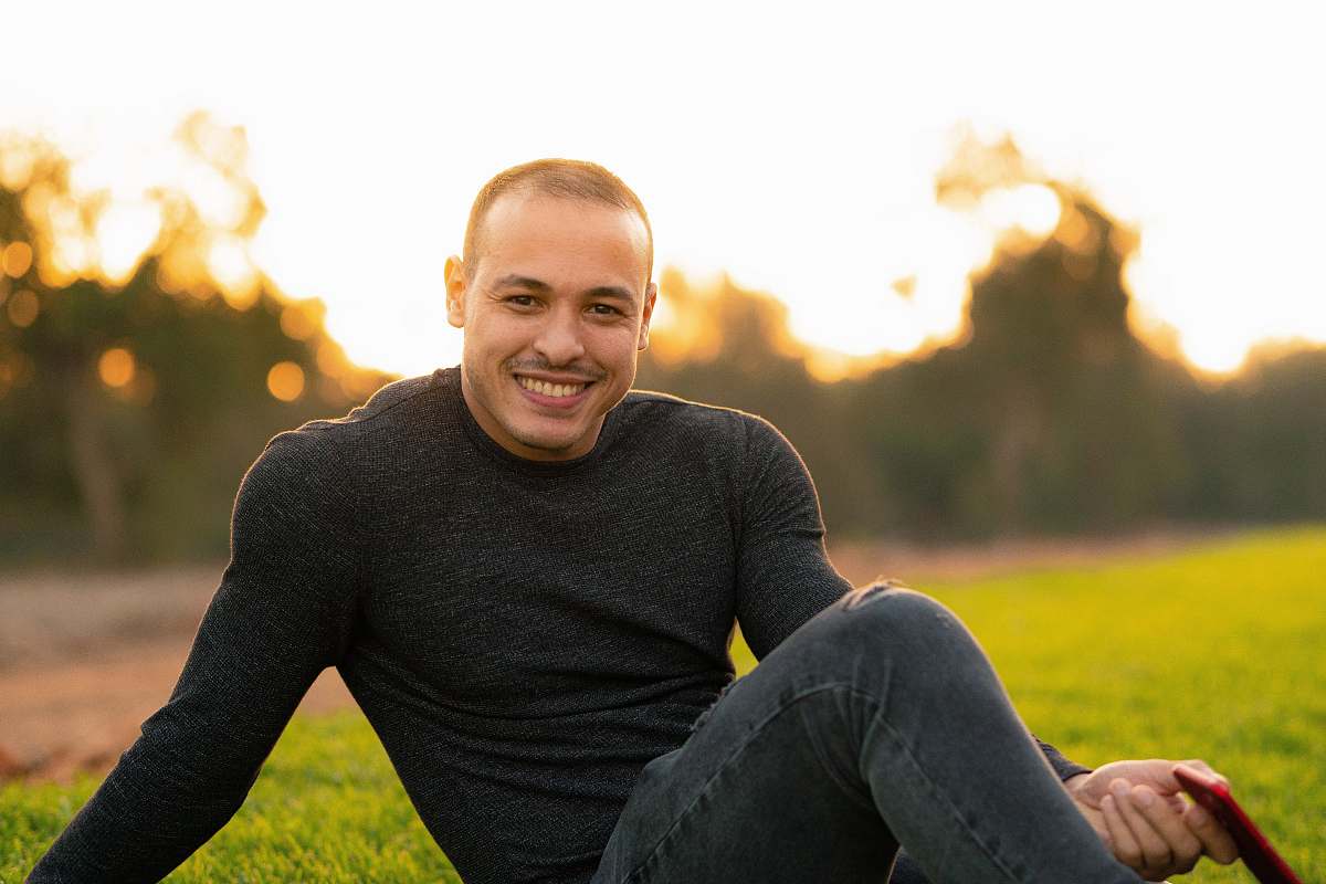 human man in black sweater on field clothing