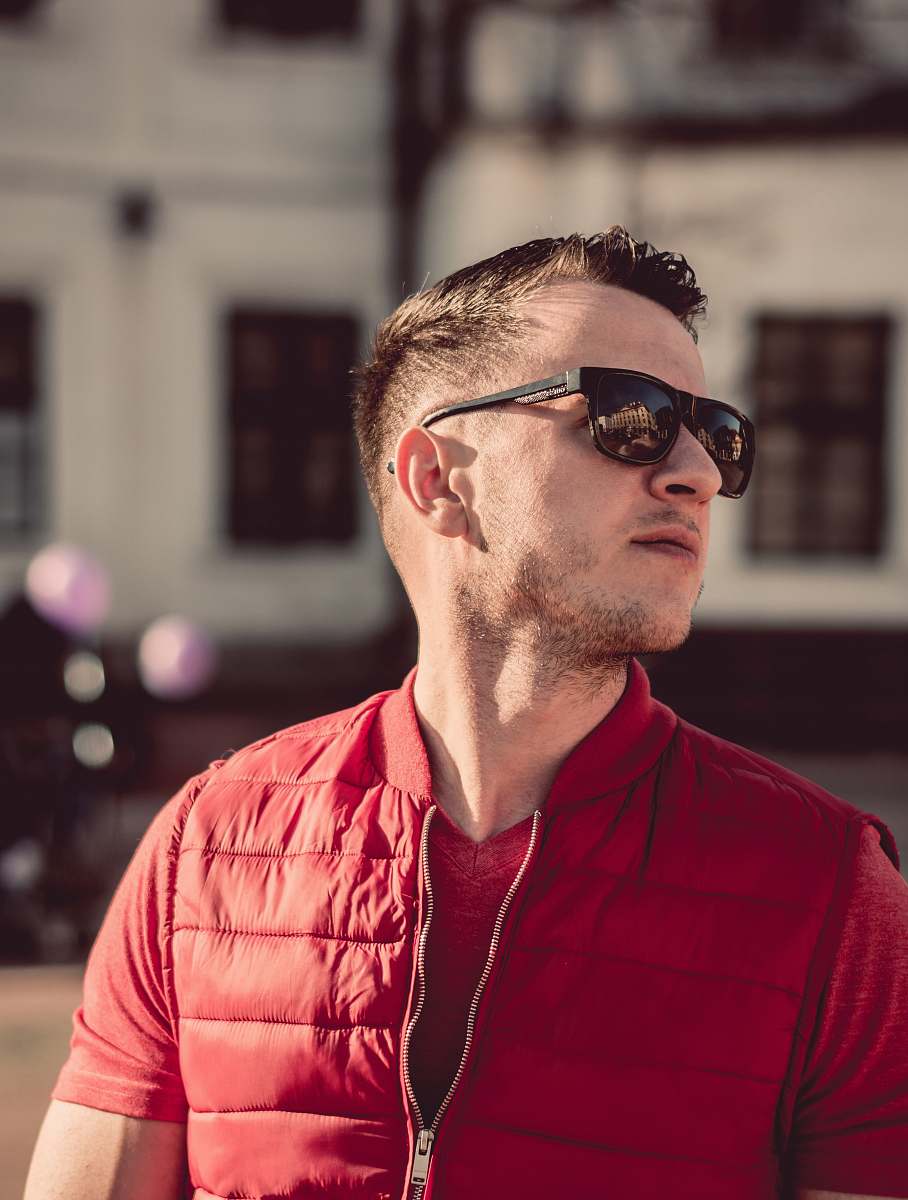 human man in red zip-up top sunglasses