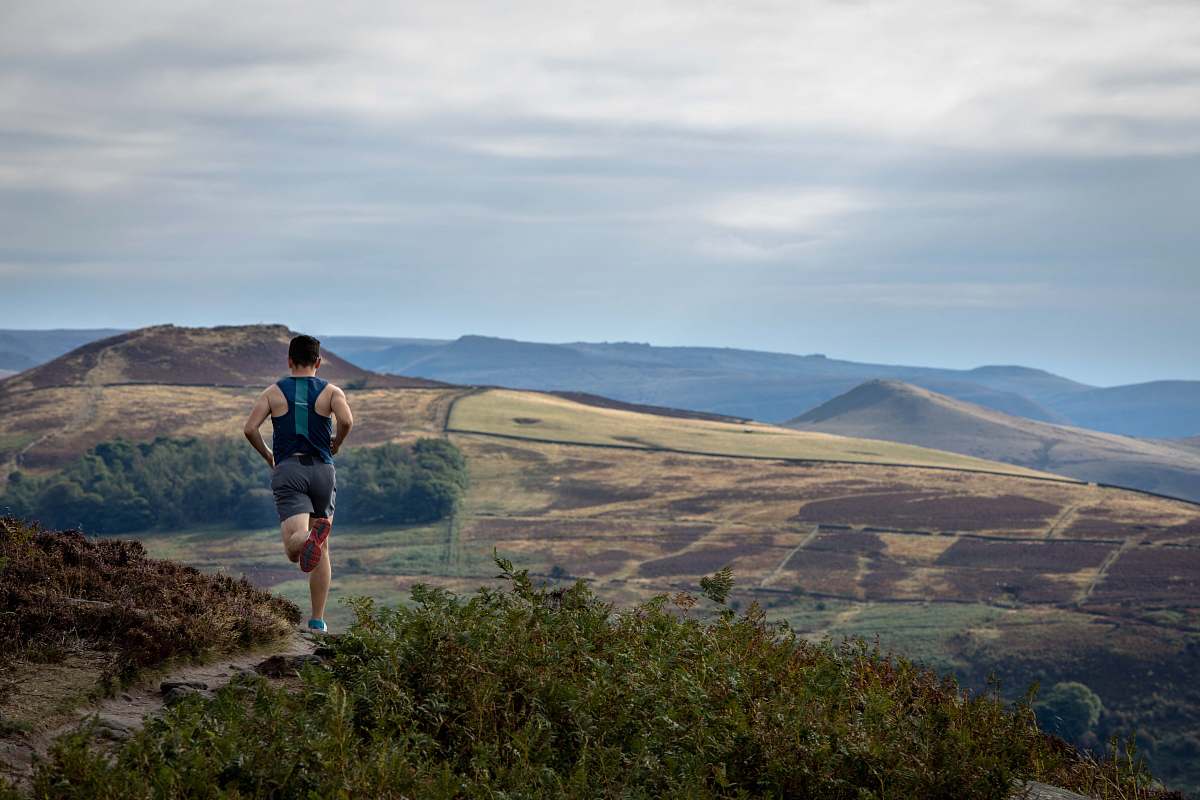 human man running on mountain outdoors