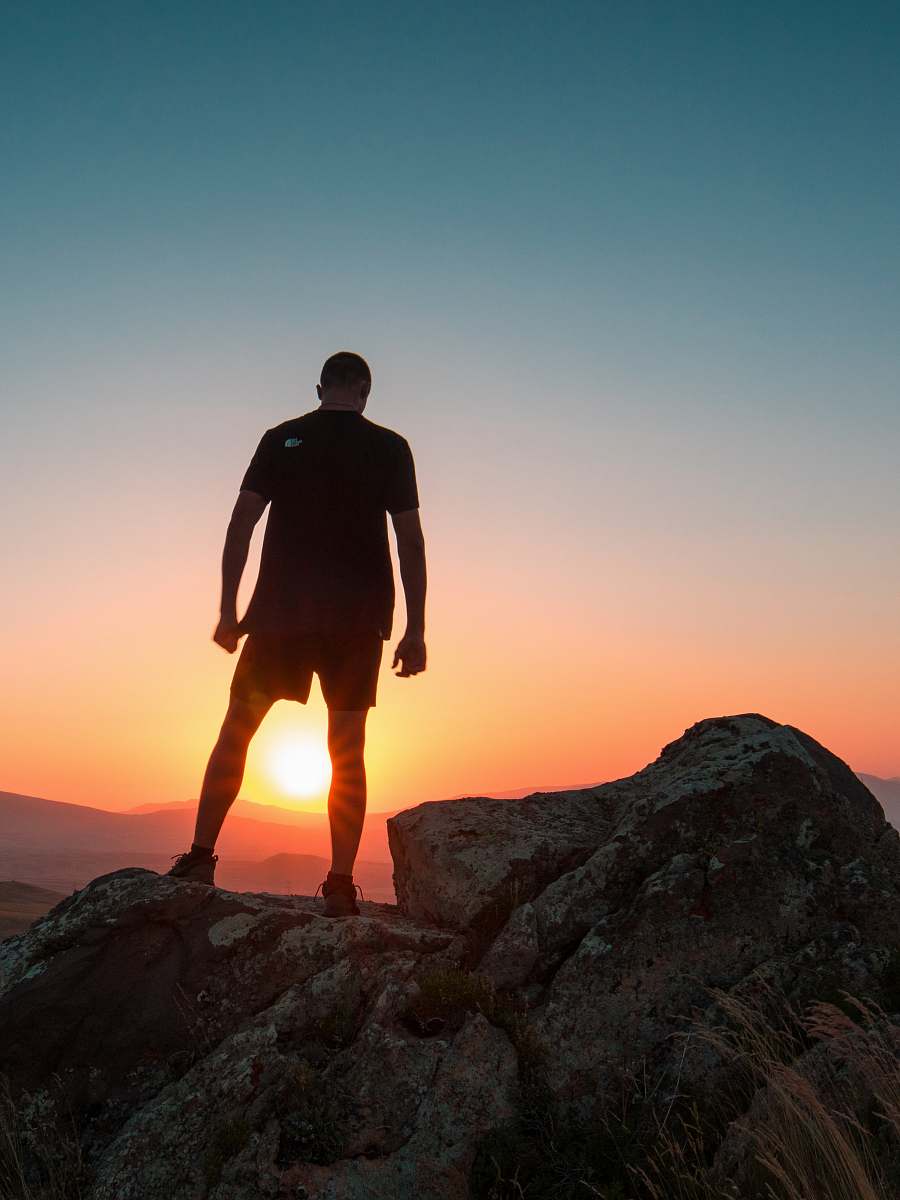 human man standing on boulder people