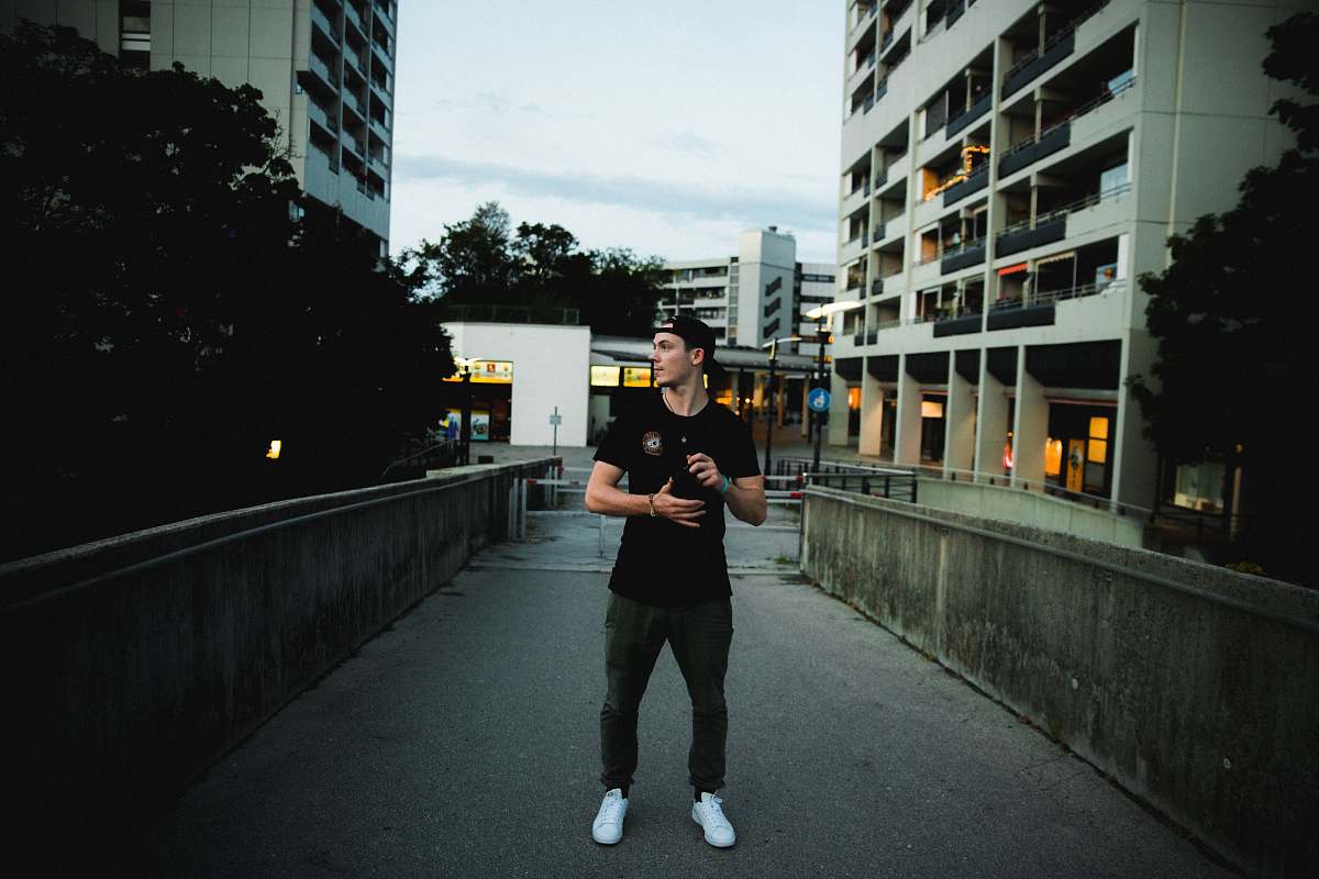 human man standing on concrete ground apparel