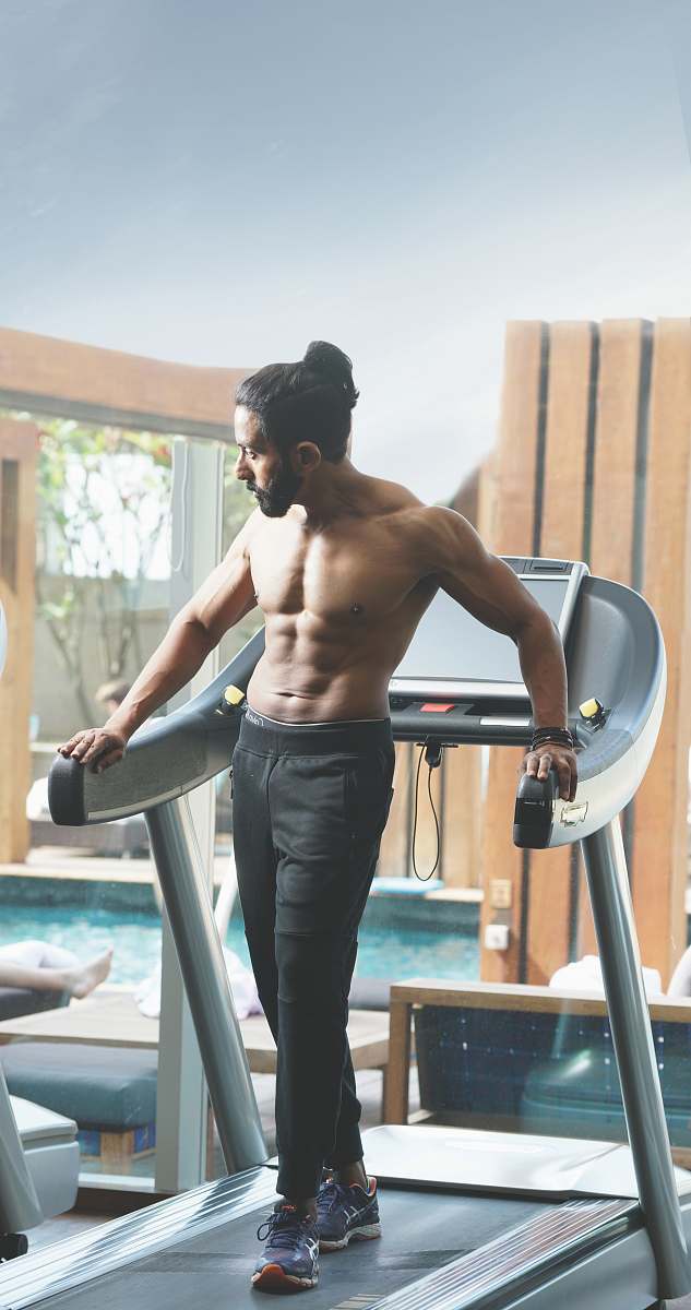 human man standing on treadmill inside room sport