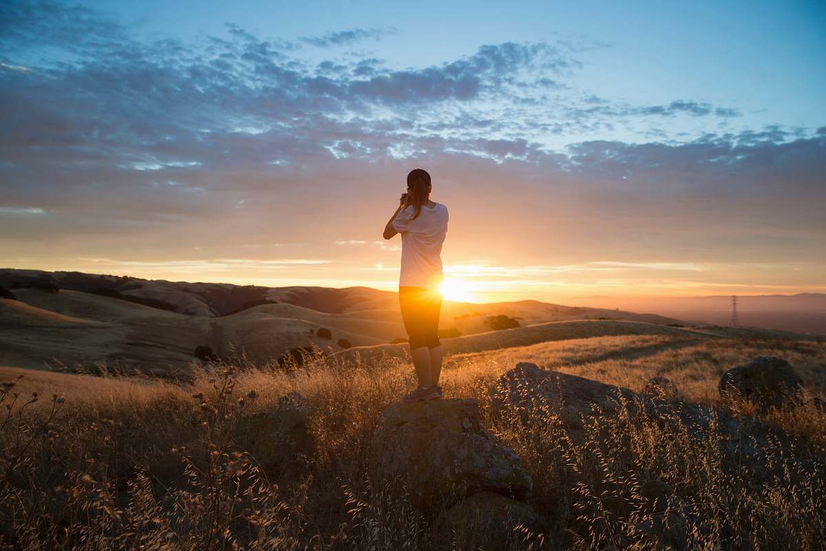 human man stands on field outdoors