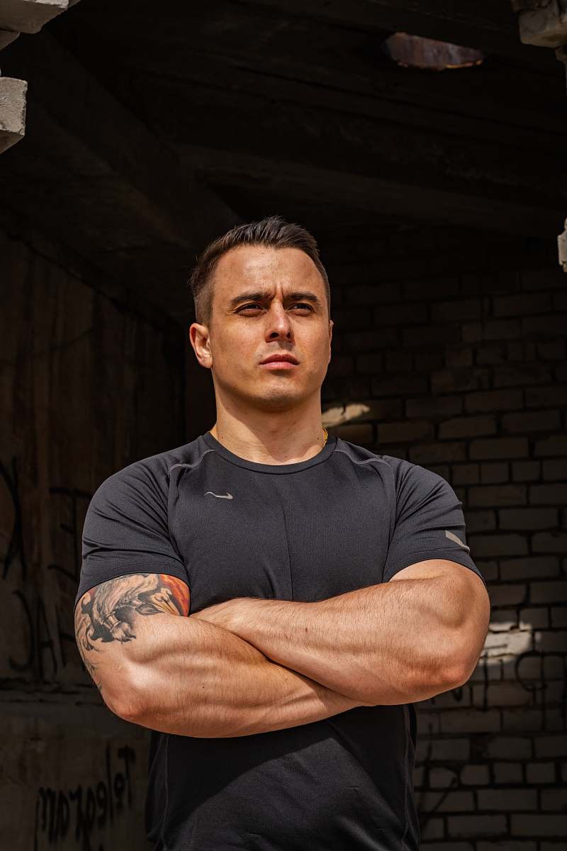 human man wrap his arms at wrecked building skin