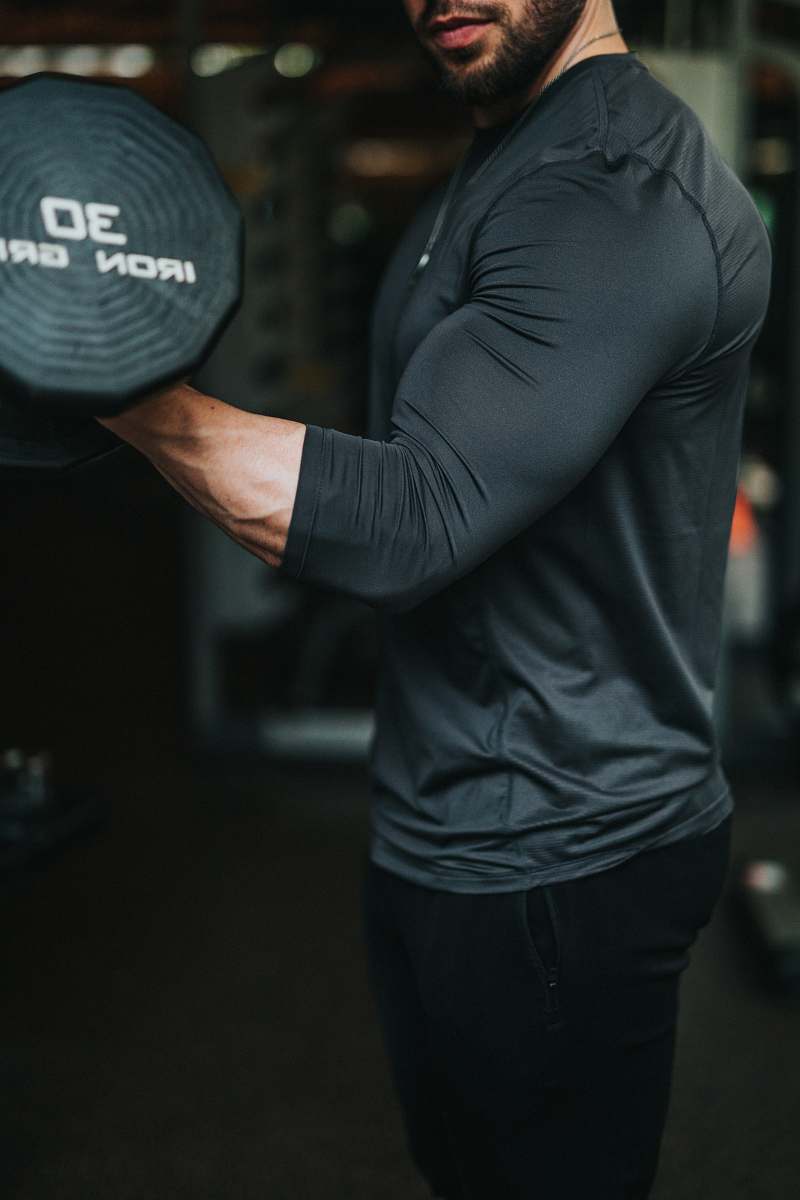 human men's black long-sleeved shirt holding dumbbell clothing