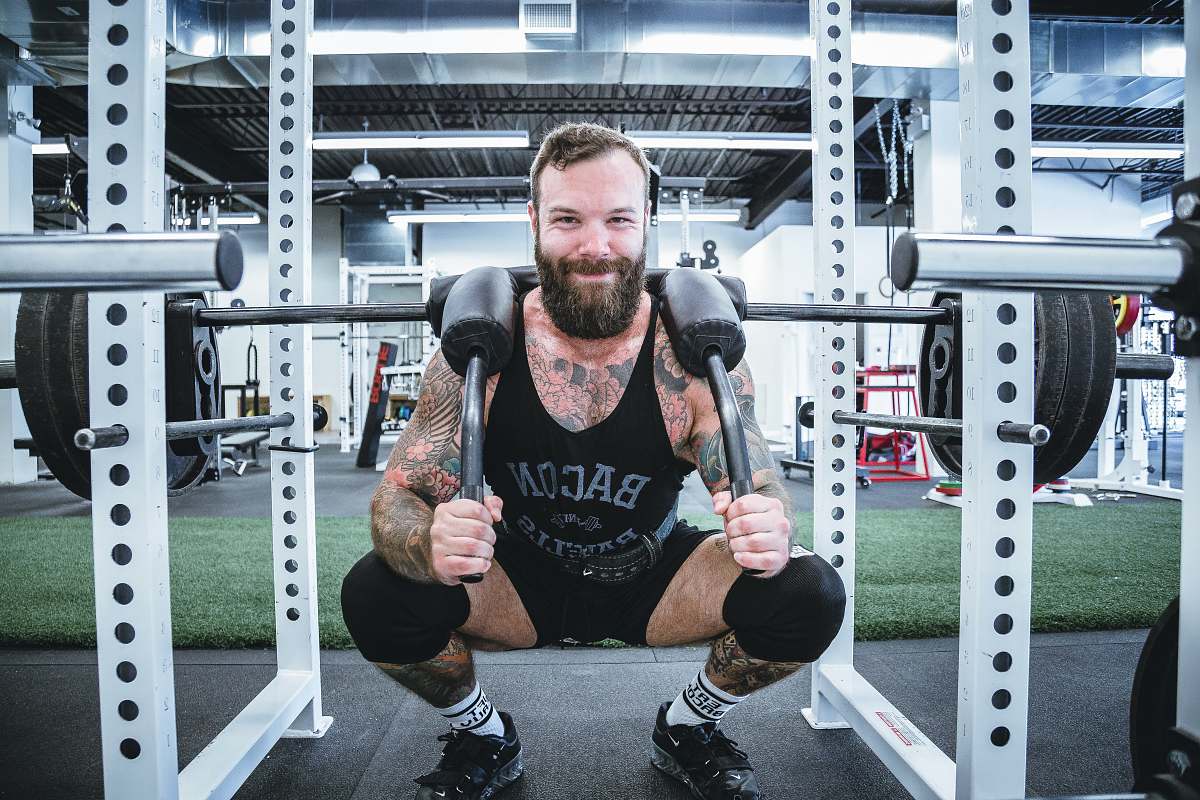 human men's black tank top and black shorts exercise
