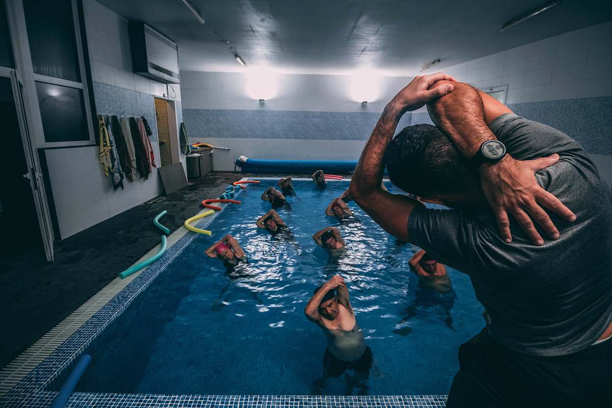 water people stretching inside pool room pool