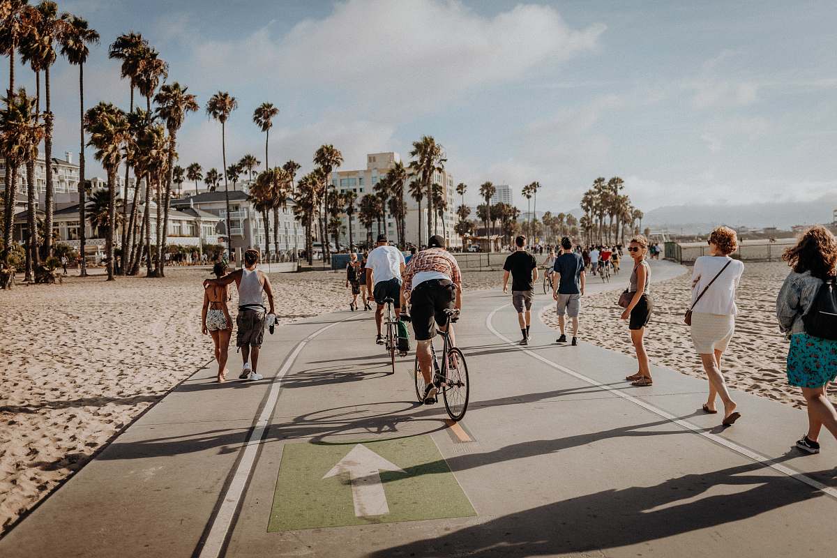 human people walking and cycling near trees bike