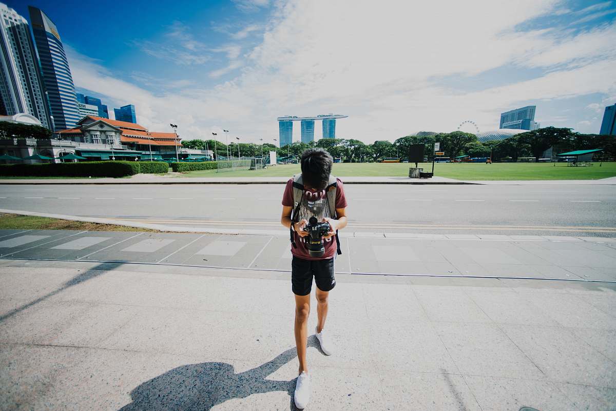 human person holding black DSLR camera people