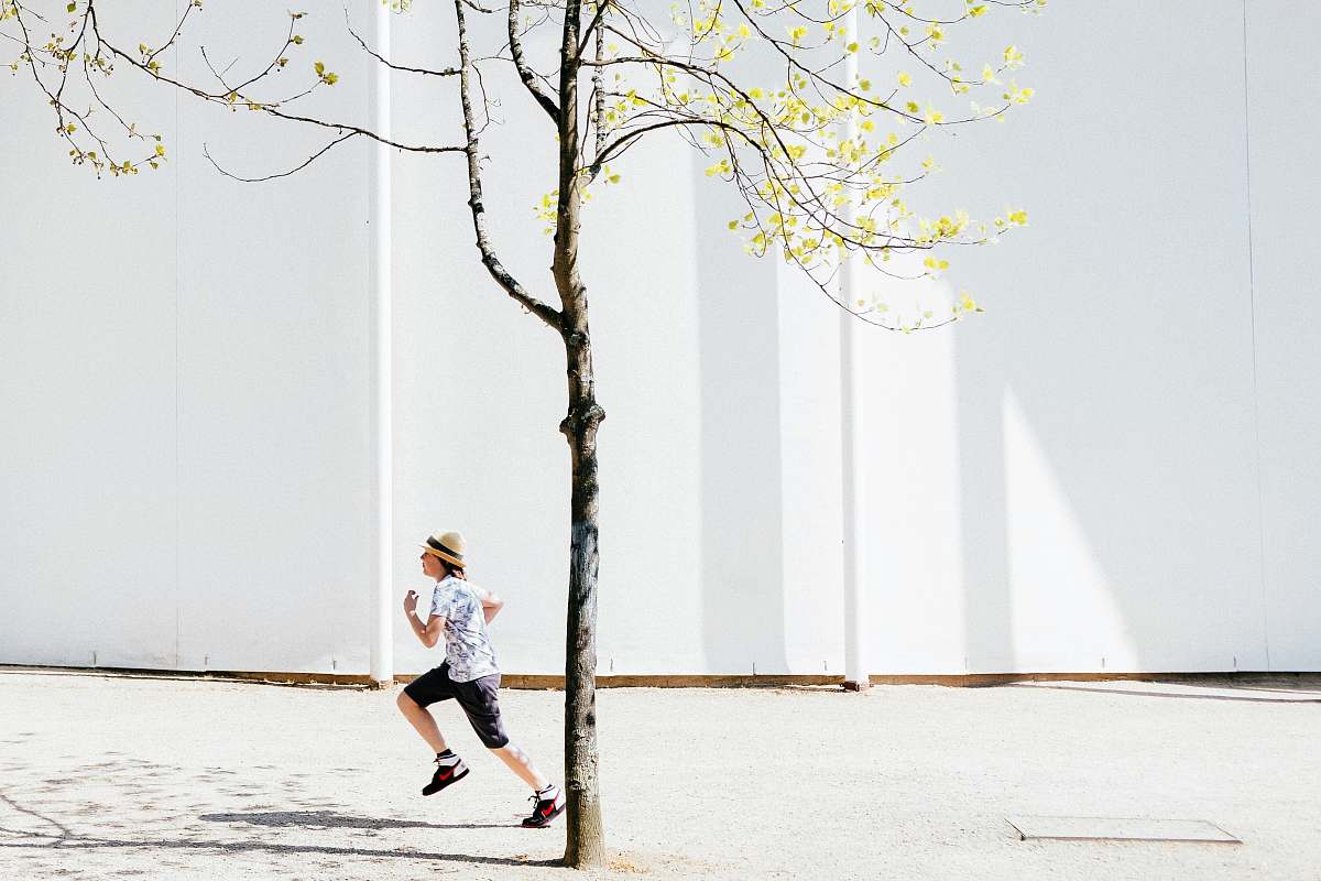 human person in white T-shirt running shorts