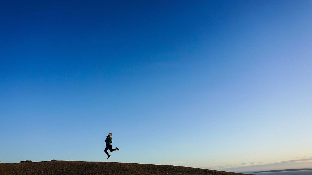human person jumping on hill blue