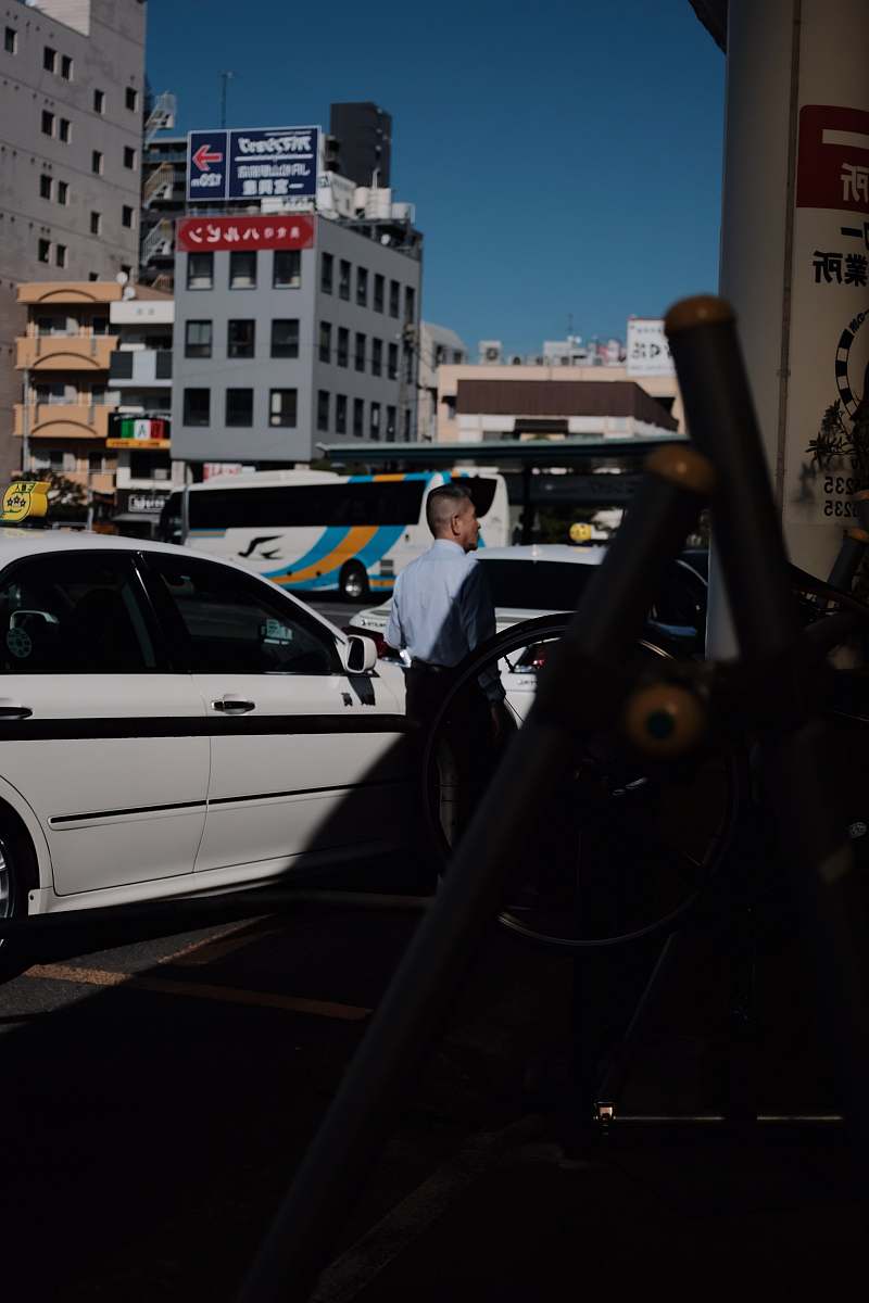 human person standing beside sedan automobile