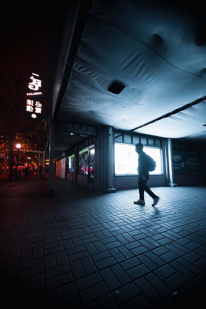 apparel person walking beside building clothing