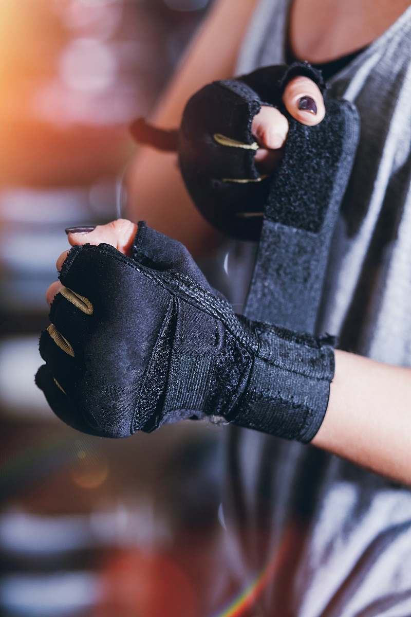 apparel person wearing black fingerless gloves clothing