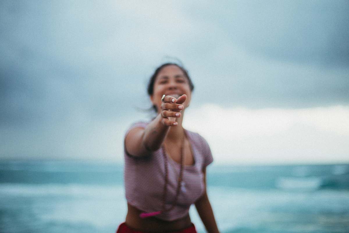 people selective focus photo of woman standing near beach human